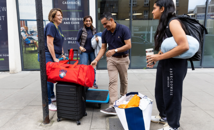 Students arriving with luggage on move-in day in London
